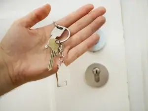 a key with a deadbolt lock on the background